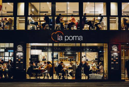 People At La Poma Store Front At Night 1383776